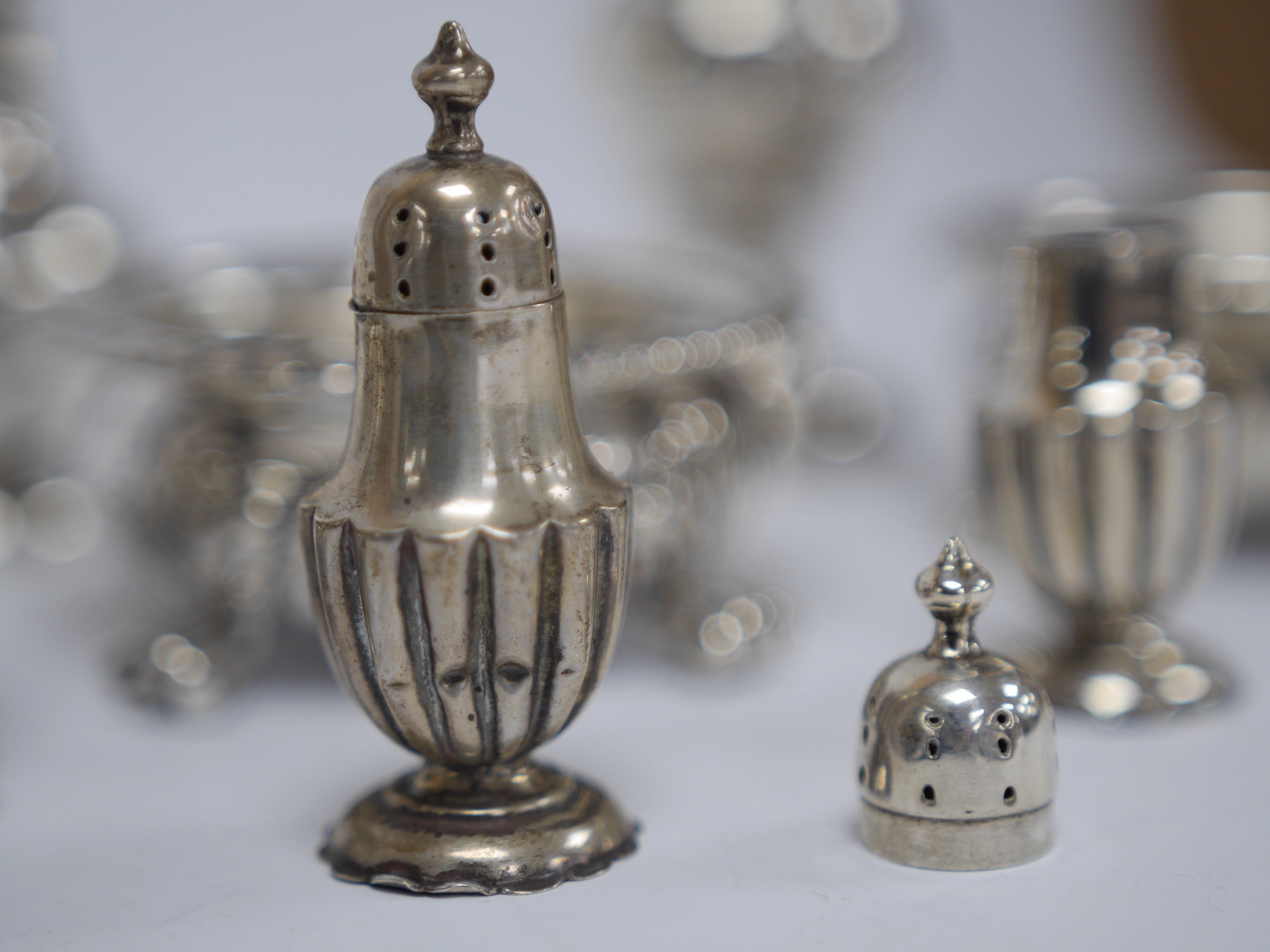 A set of three George IV silver circular salts, by Matthew Boulton Plate Co, diameter 86mm and four other later silver condiments, 14.7oz. Condition - poor